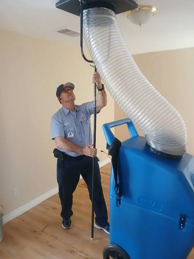 Furnace Tune-Up technician using HEPA equipment in Colville